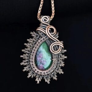 Natural green and pink ruby zoisite crystal cabochon framed in a premium copper wire wrap.