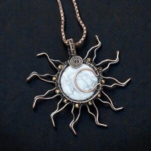 Marble textured white howlite gemstone encased in a celestial sunburst copper wire wrap.